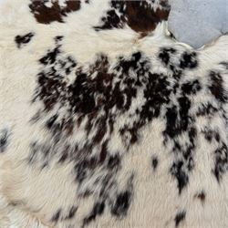 Skins/Hides: Large cow hide rug (Bos taurus), with dark brown and white dapple pattern, W78cm