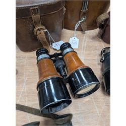 Four pairs of early 20th century binoculars, including Carl Zeiss Jena Feldstecher binoculars, Carl Zeiss Telact 8x binoculars, Dollond x5 field binolculars and one other pair, all in leather cases, one case marked with broad arrow, some with officers name etched