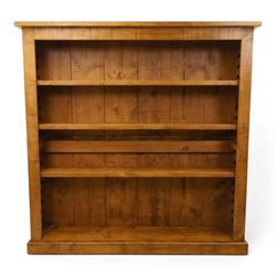 Indigo Furniture - large rustic oak open bookcase, with four adjustable shelves, above a p...