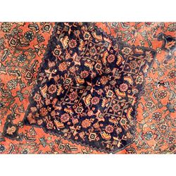 Persian Zanjan pale red ground rug, lozenge medallion and field decorated with floral Herati motifs, the border decorated with stylised plant motifs and trailing branches, floral pattern guard stripes