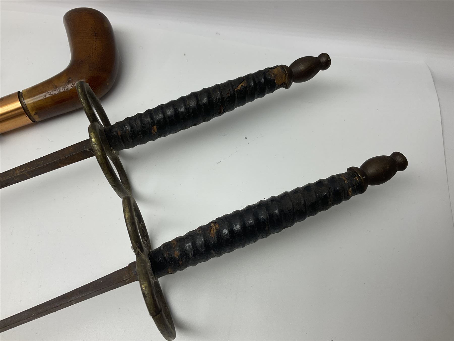 Leather covered swagger/sword stick with 40cm steel blade L62cm overall; another ash sword stick with 30cm diamond section steel blade; pair of fencing foils, the blades marked Solingen; two reproduction flintlock pistols; and 92cm inert cartridge belt (7)