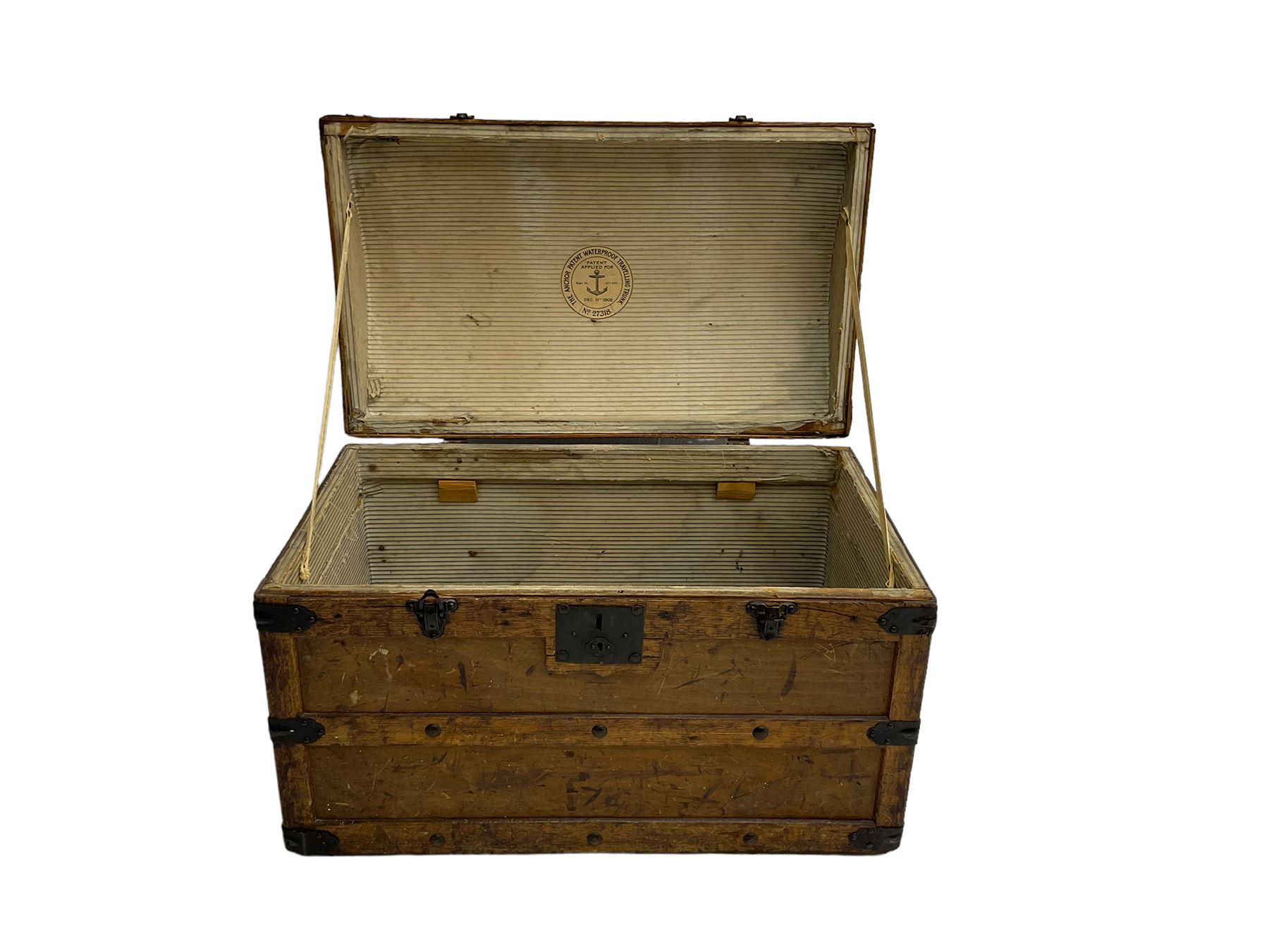 Late 19th to early 20th century oak framed travelling trunk, dome top with iron fittings and panelled sides and top, interior labelled 'The Anchor Patent Waterproof Travelling Trunk - 1902'