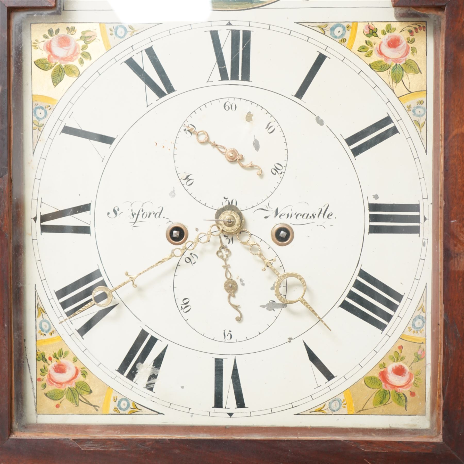 Sinford, of Newcastle - mid 19th century Oak and Mahogany 8-day  longcase clock c1840, with a break-arched pediment and three brass ball and spire finials, break arch hood door flanked by turned pilasters with wooden capitals, trunk with a long door with cross banding and a gable top, rectangular plinth with a integral shaped base, painted dial with floral depictions to the spandrels and a pastoral scene to the arch, with Roman numerals, seconds and date dials and stamped brass hands, rack striking movement , striking the hours on a bell. With weights and pendulum.