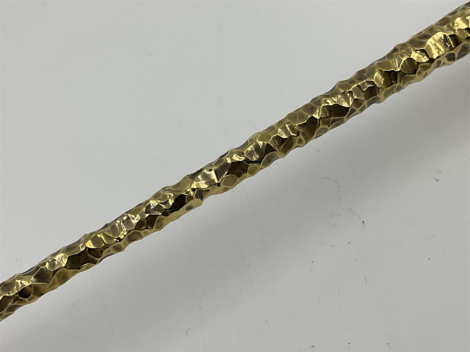 Pair of modern silver candlesticks by Stuart Devlin, the tapering parcel gilt stems with signature textured detailing, each supporting a fluted candle holder and upon a spreading circular foot, hallmarked Stuart Devlin, London 1973, H25cm