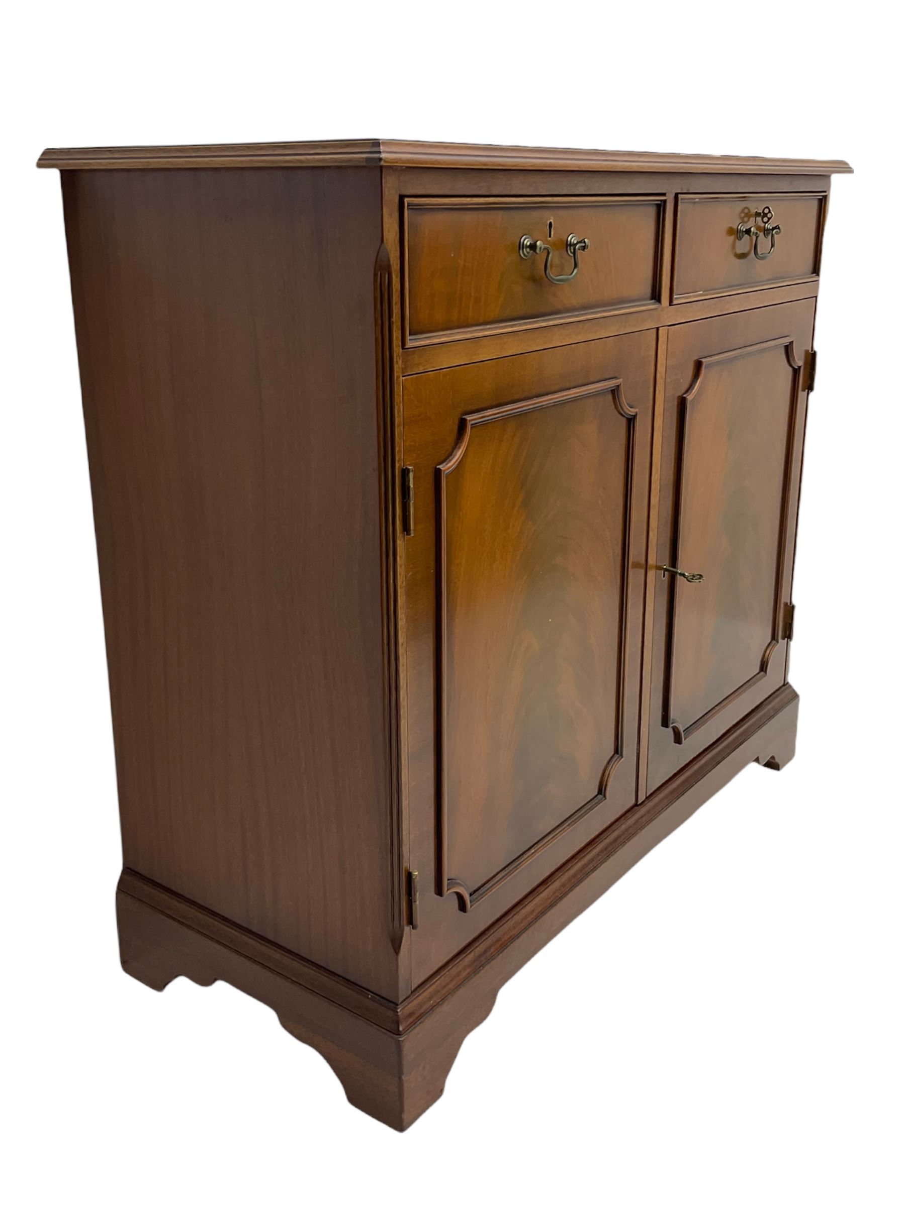 Reproduction mahogany side cabinet, moulded rectangular top over two drawers and double cupboard, bracket feet