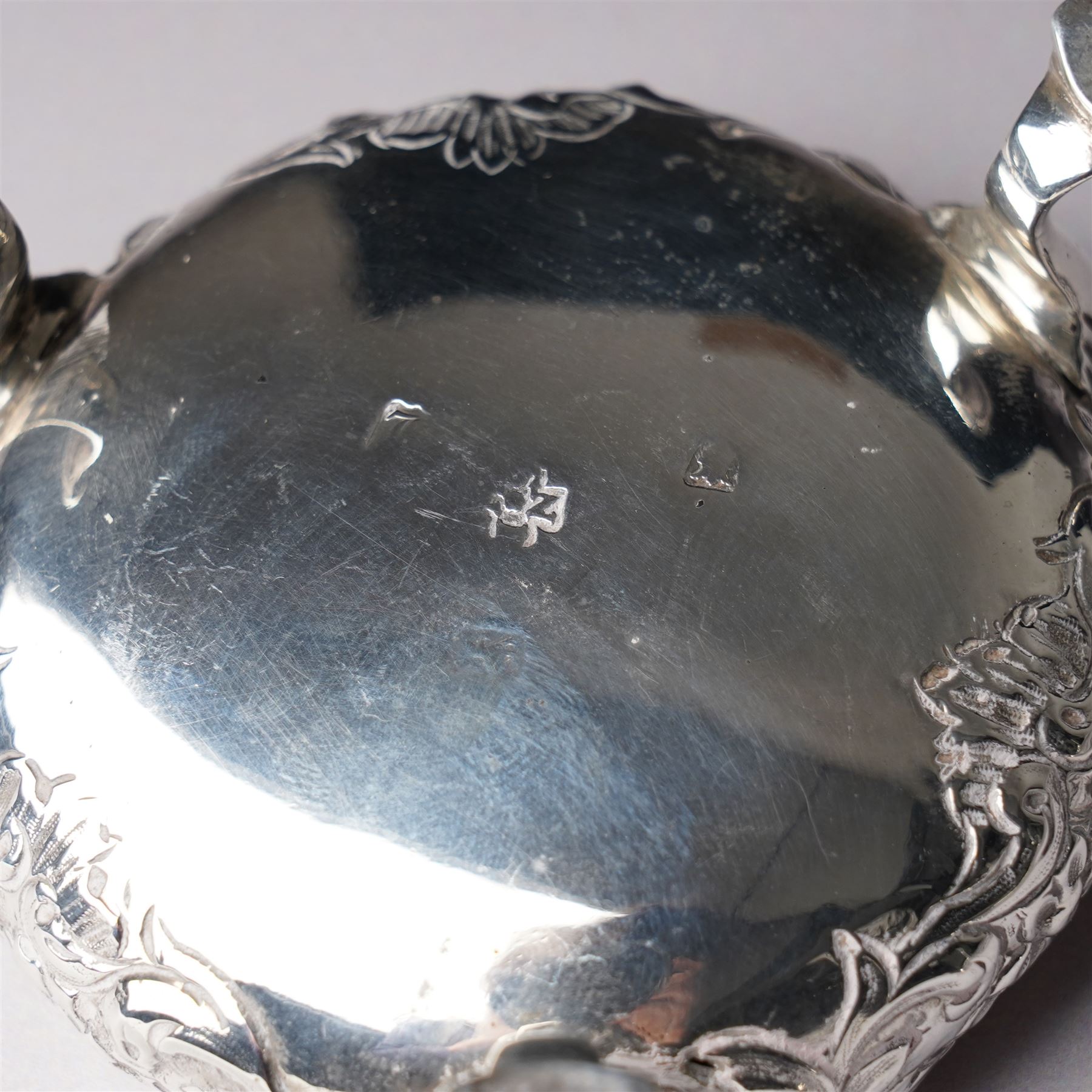 Pair of George III silver circular salts with gilded interiors and embossed decoration and two 19th century condiment spoons, one by Peter and Ann Bateman 