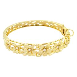 14ct gold diamond flower head hinged bangle, seven graduating flowers, each set with a sin...