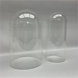 Tabletop glass display cabinet, with hinged door, together with two glass domes