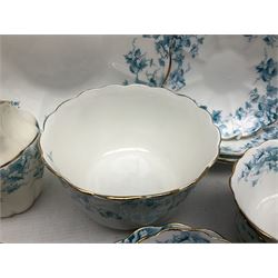 Edwardian David Chapman & Sons tea service for six, of lobed form decorated with blue transfer printed foliate decoration and gilt rims