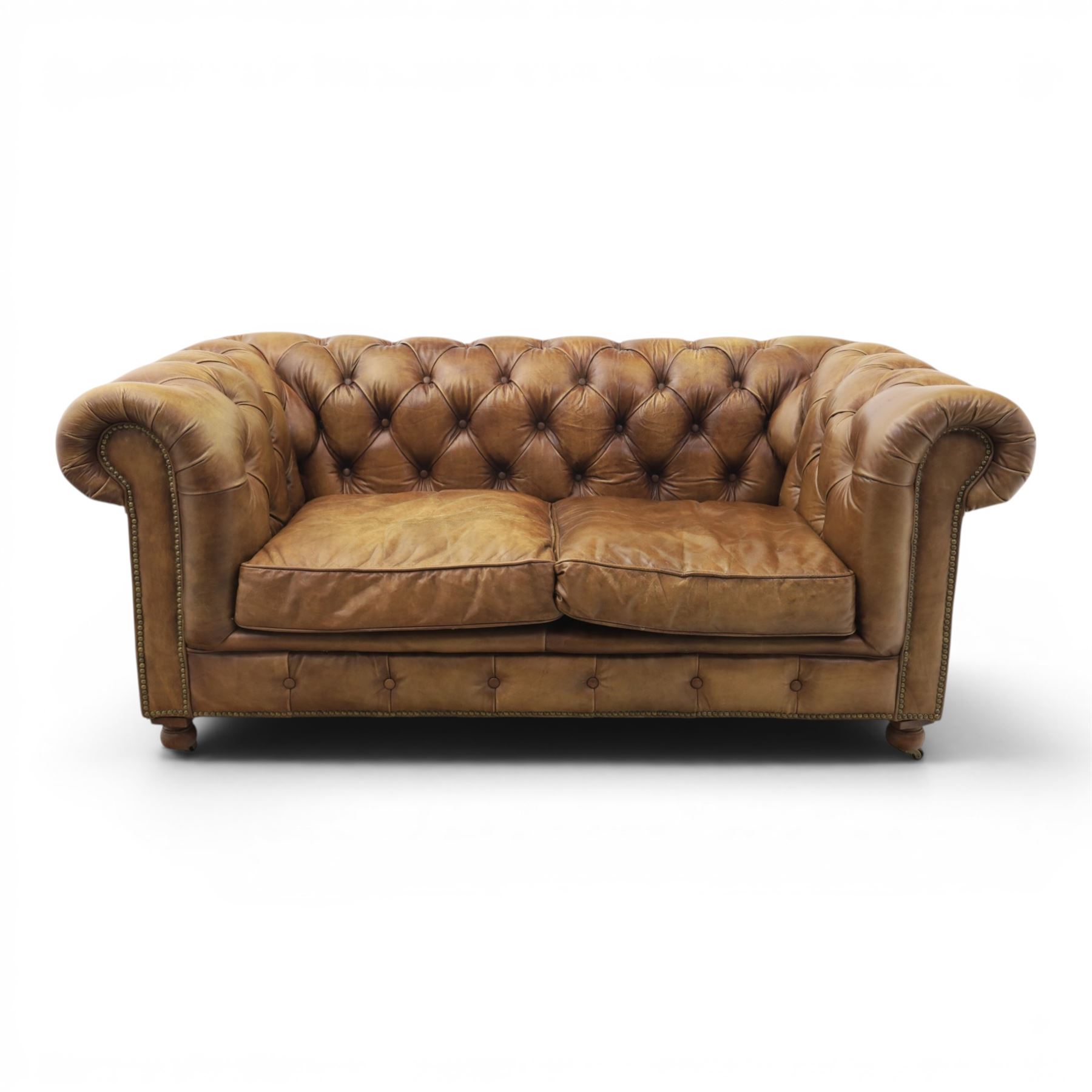 HALO - Chesterfield style two seat sofa upholstered in buttoned brown leather with stud work, on turned feet with castors