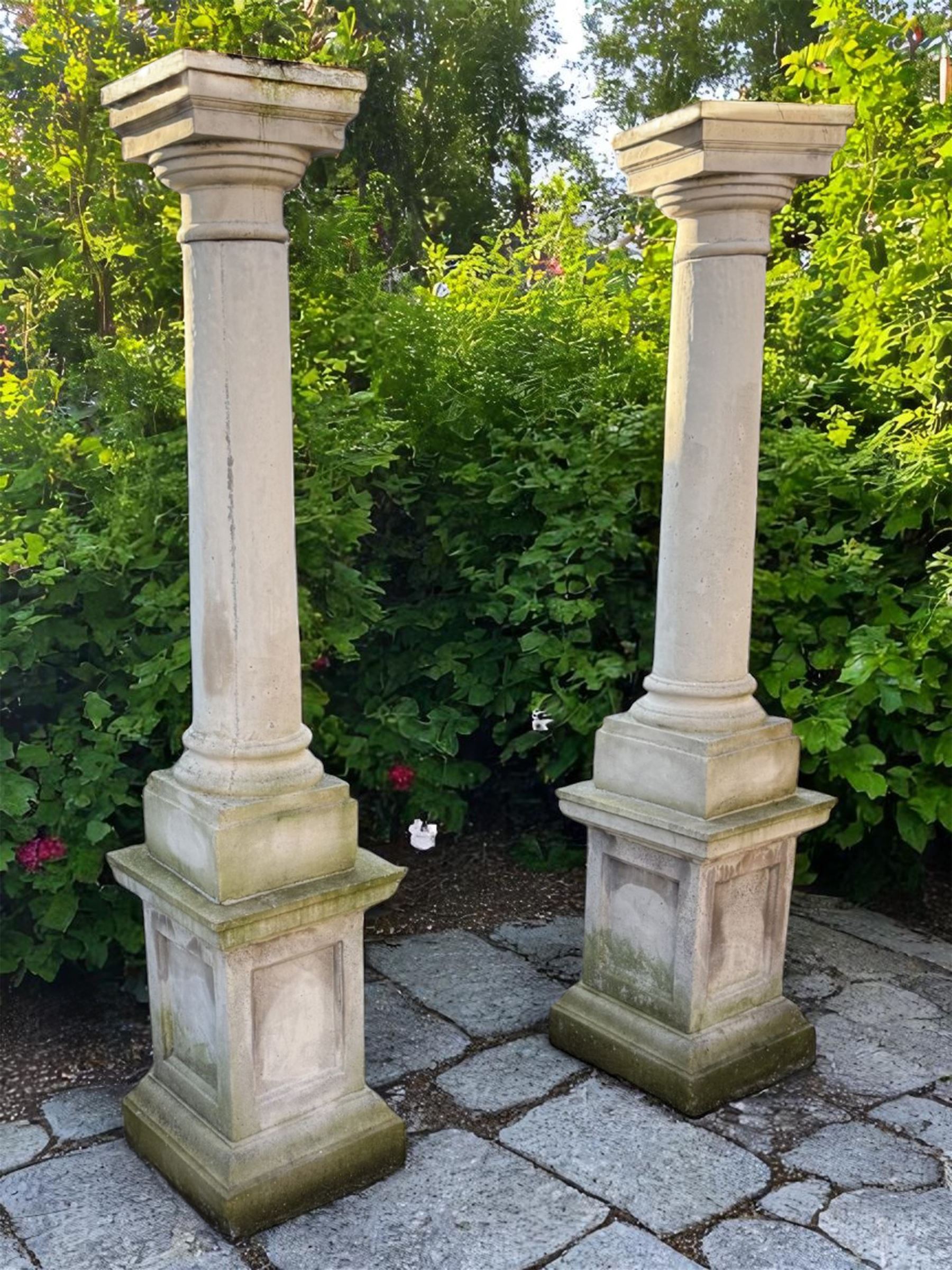 Set of four cast stone architectural columns, tapering form, on square plinth bases