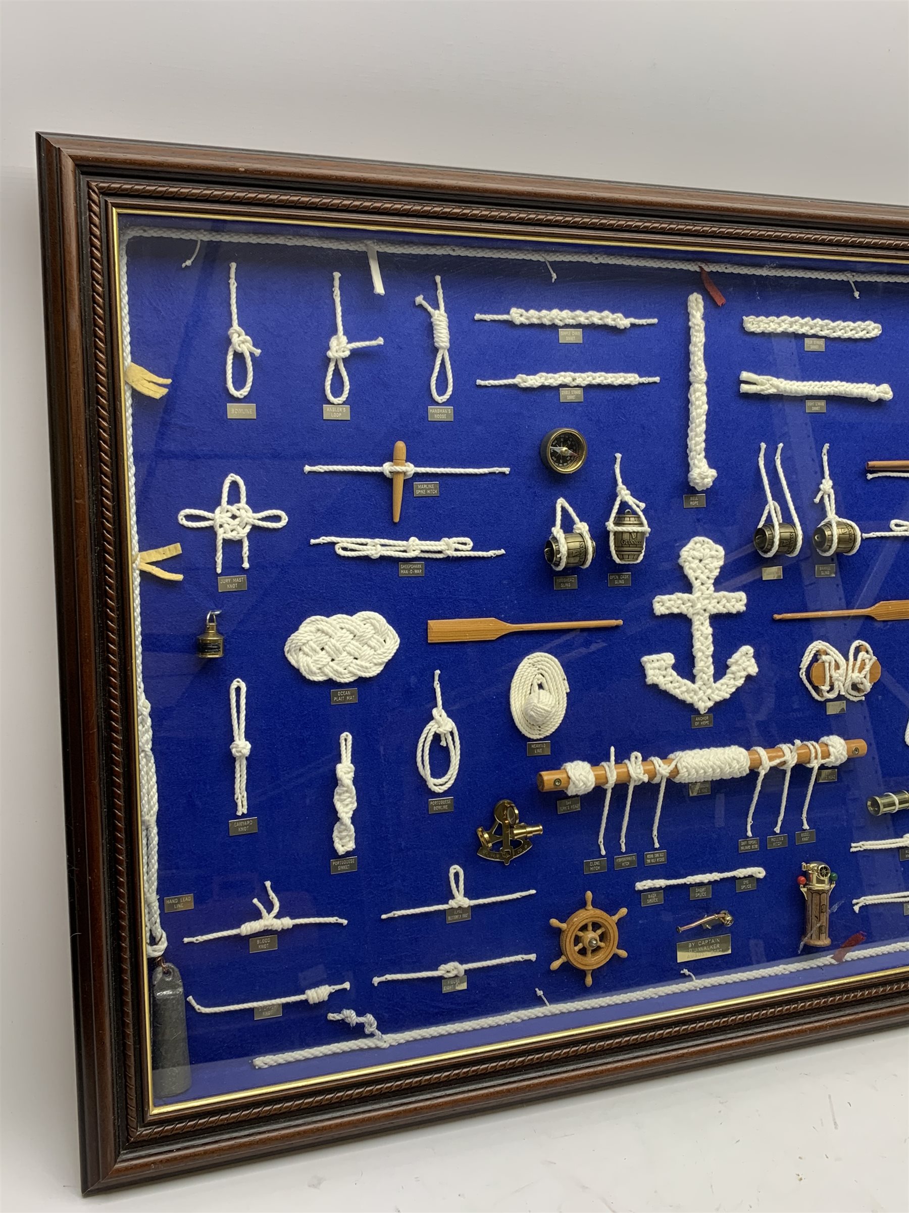  Large framed knot board, including miniature Binnacle, ships wheel and sextant, by Captain D.J.Walker August 2007, W90cm, H60cm,  Provenance:  Captain Walker was captain of the North Sea Ferry Norland which was later requisitioned by the MOD to be used as a Troopship to be sent to the Falkland Islands  