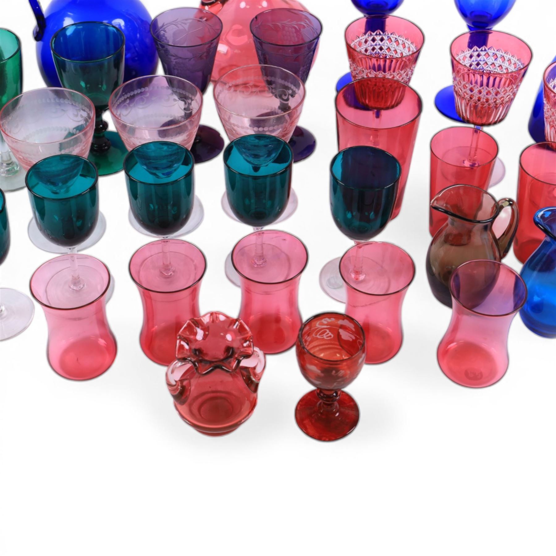 Group of Victorian and later coloured glassware, to include Victorian blue glass flagon, and similar green example, each with metal moulded rim, assorted cranberry, green, amethyst and blue glass drinking glasses, etc., in one box