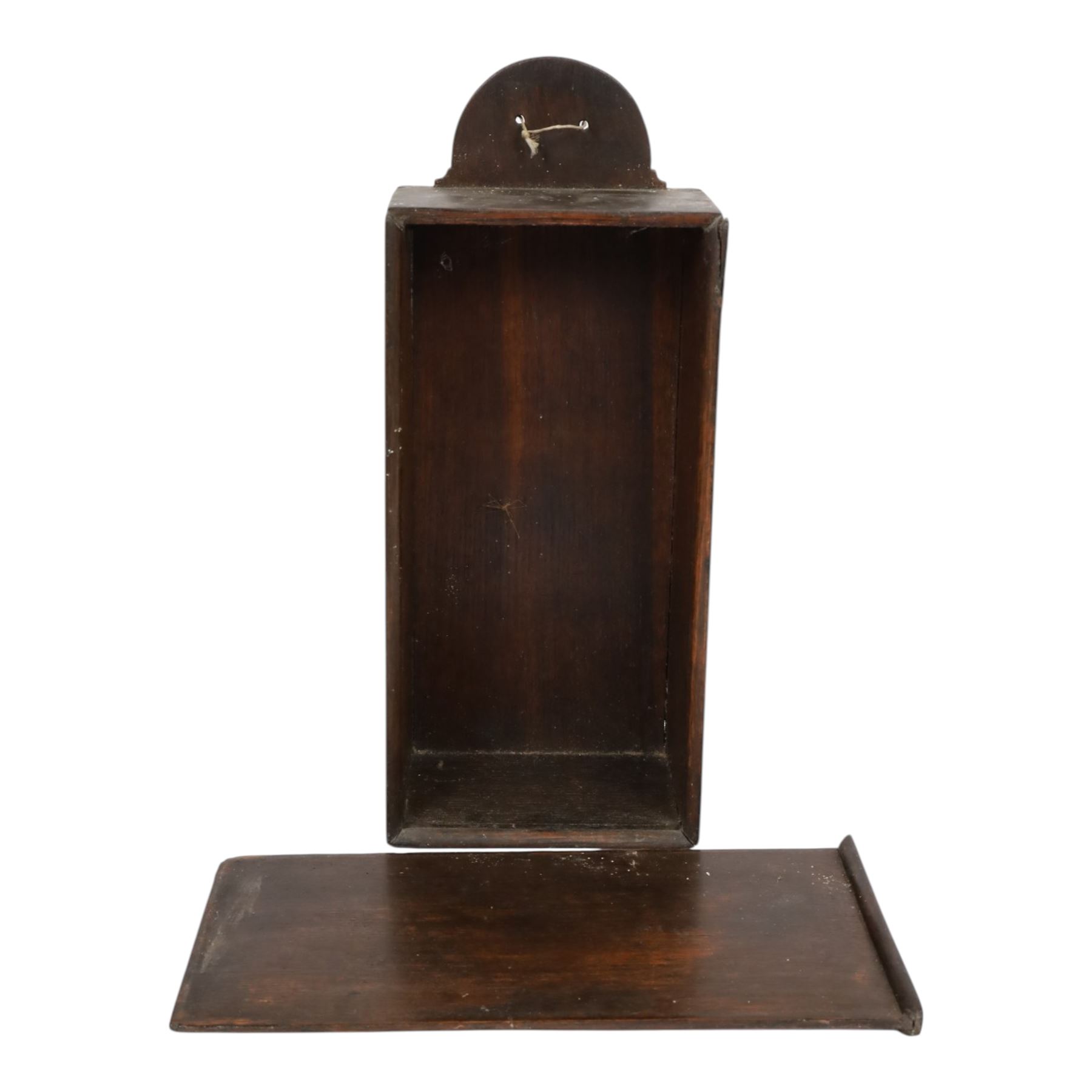 Three George III and later oak candle boxes, the first example of tapering form with shaped and pierced scroll crest, above a hinged lid, H50.5cm W18cm D13cm, the second of plain rectangular form with tapering crest, above a studded leather hinged sloped lid, H46cm W15.5cm D15.5cm, and third of plain rectangular form with demi-lune crest, with lift up front, H42.5cm W17.5cm D12cm 

