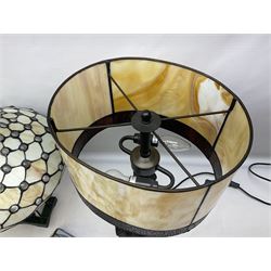 Three Tiffany style table lamps with leaded shades, to include a panelled amber example with bronzed base, H50cm incl shade, together with two further leaded shades