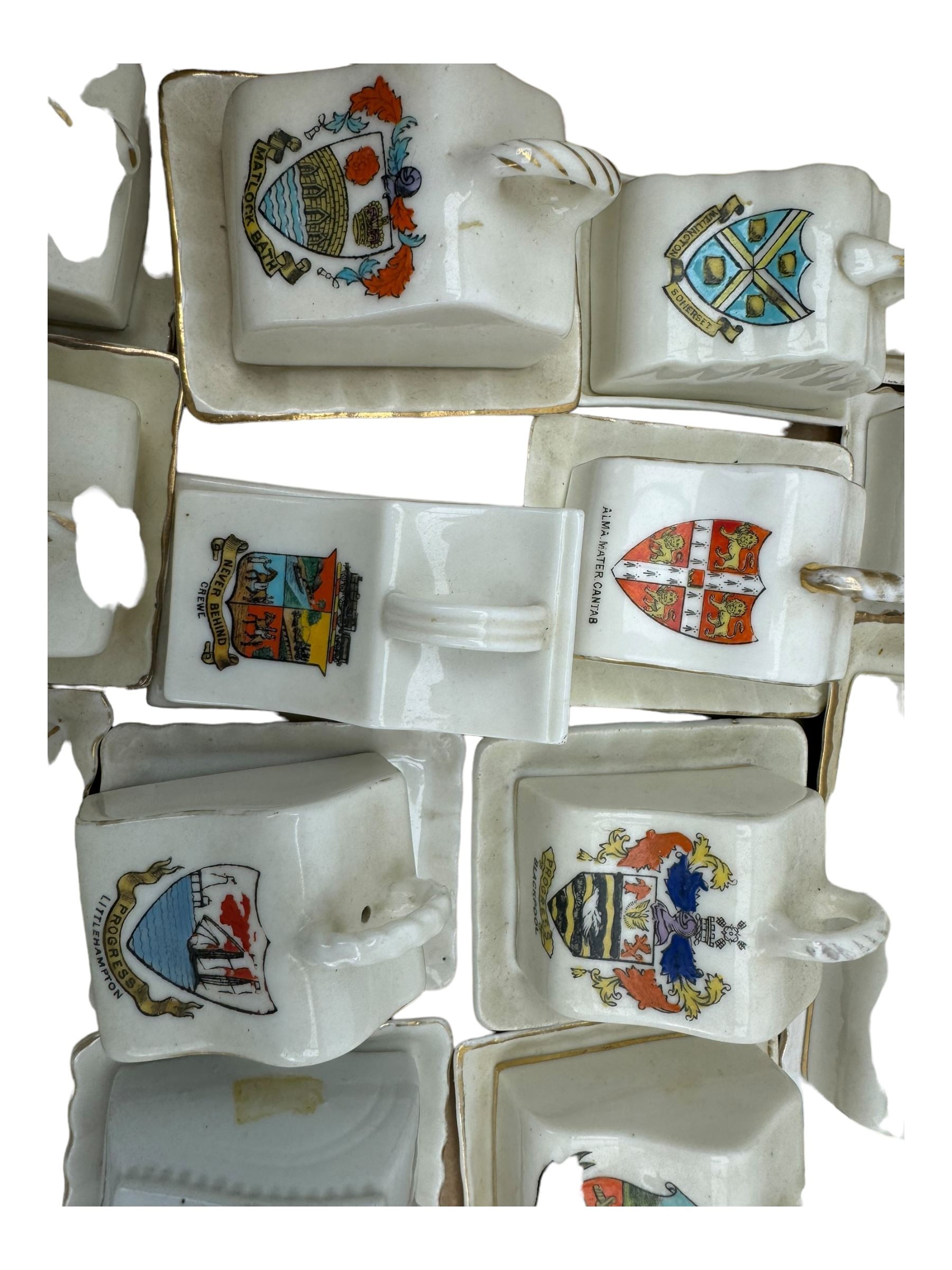 Collection of crested ware miniature cheese dishes and covers, including one by Goss, in one box