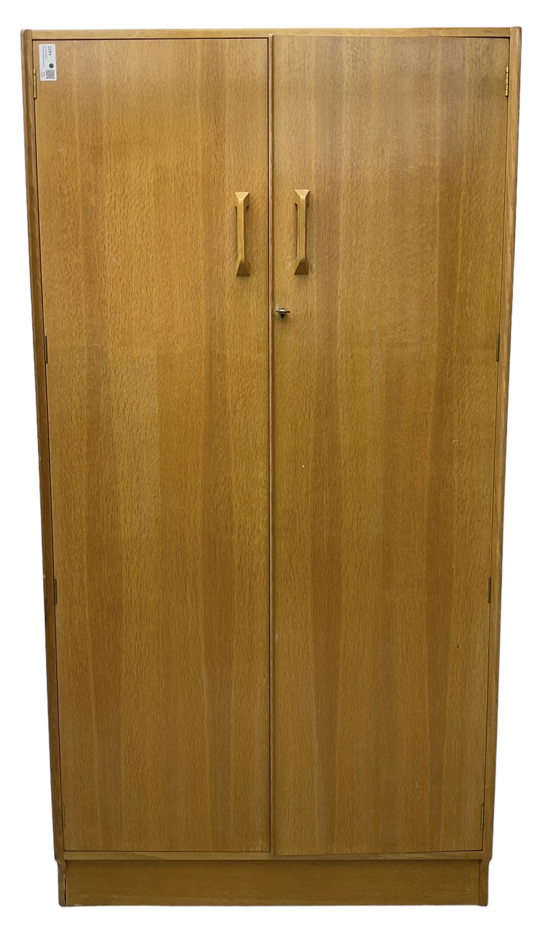 E. Gomme for G-Plan - 'Brandon' light oak double wardrobe, the interior fitted with hanging rail and shelves 