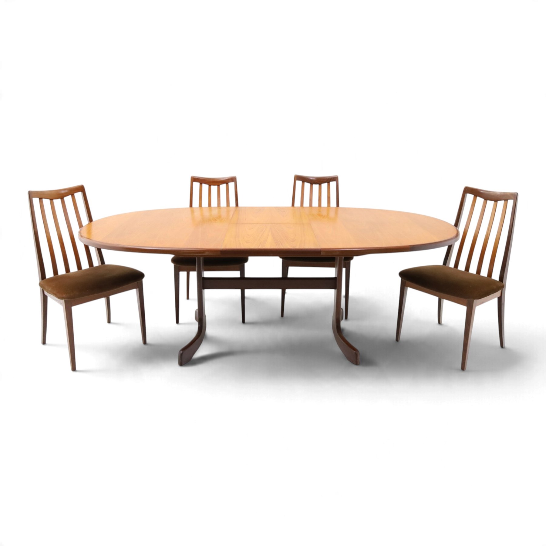 G Plan - Mid 20th century teak extending dining table and four chairs, oval top with stowed fold-over leaf extending to 208cm, raised on two shaped supports united by a stretcher 