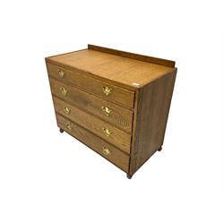 Mid-20th century oak chest, raised back, fitted with four graduating drawers, on castors