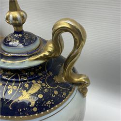 19th century Vienna style porcelain 'Musik' garniture, the central vase of baluster form with domed cover flanked by two smaller vases with twin curved gilt handles to short neck, each decorated with classical figural vignettes between blue borders heightened with gilt, H33.5cm