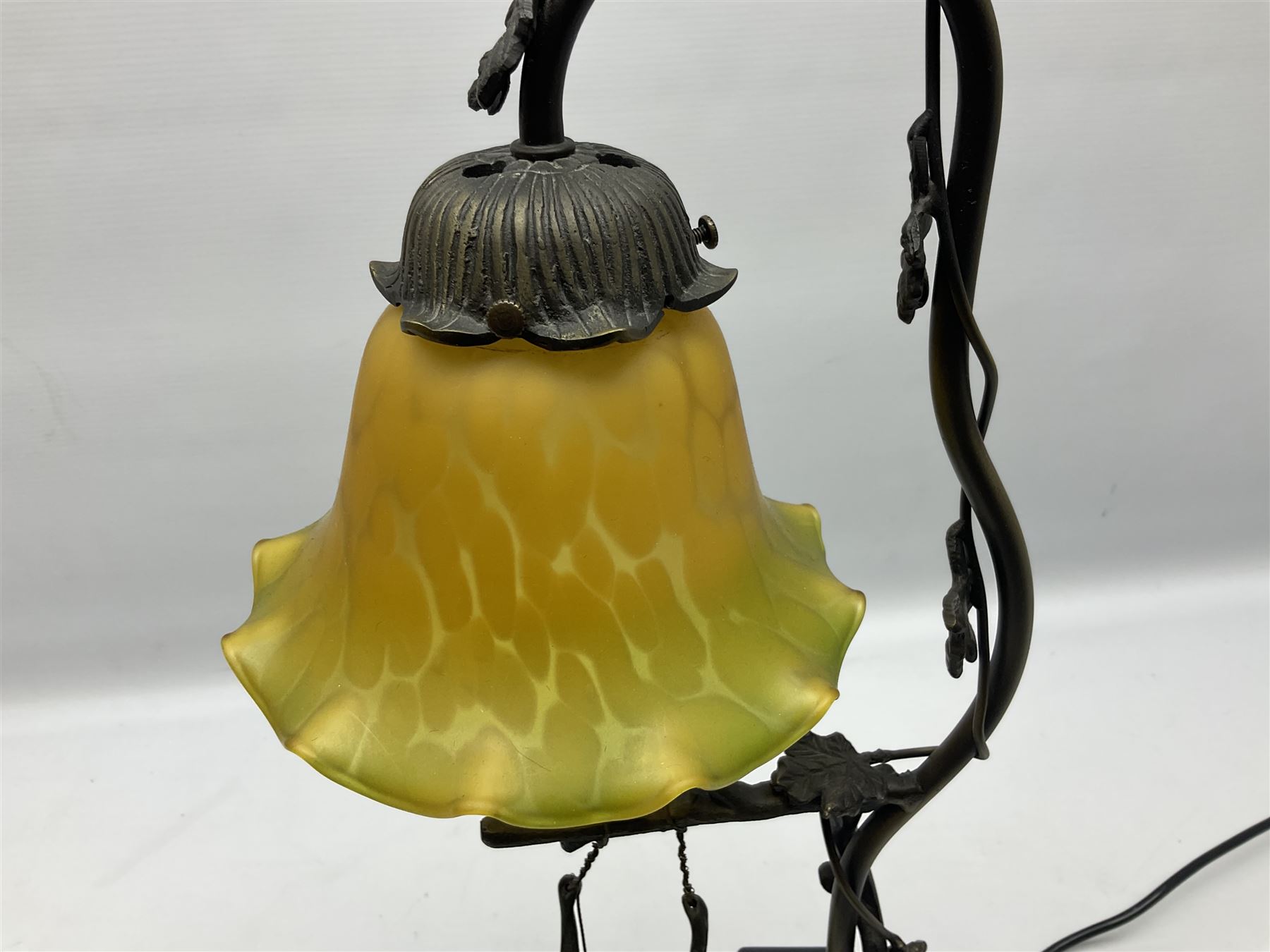 Art Nouveau style lamp in the form of a woman on a swing, with a green mottled shade, upon a marble base H52cm