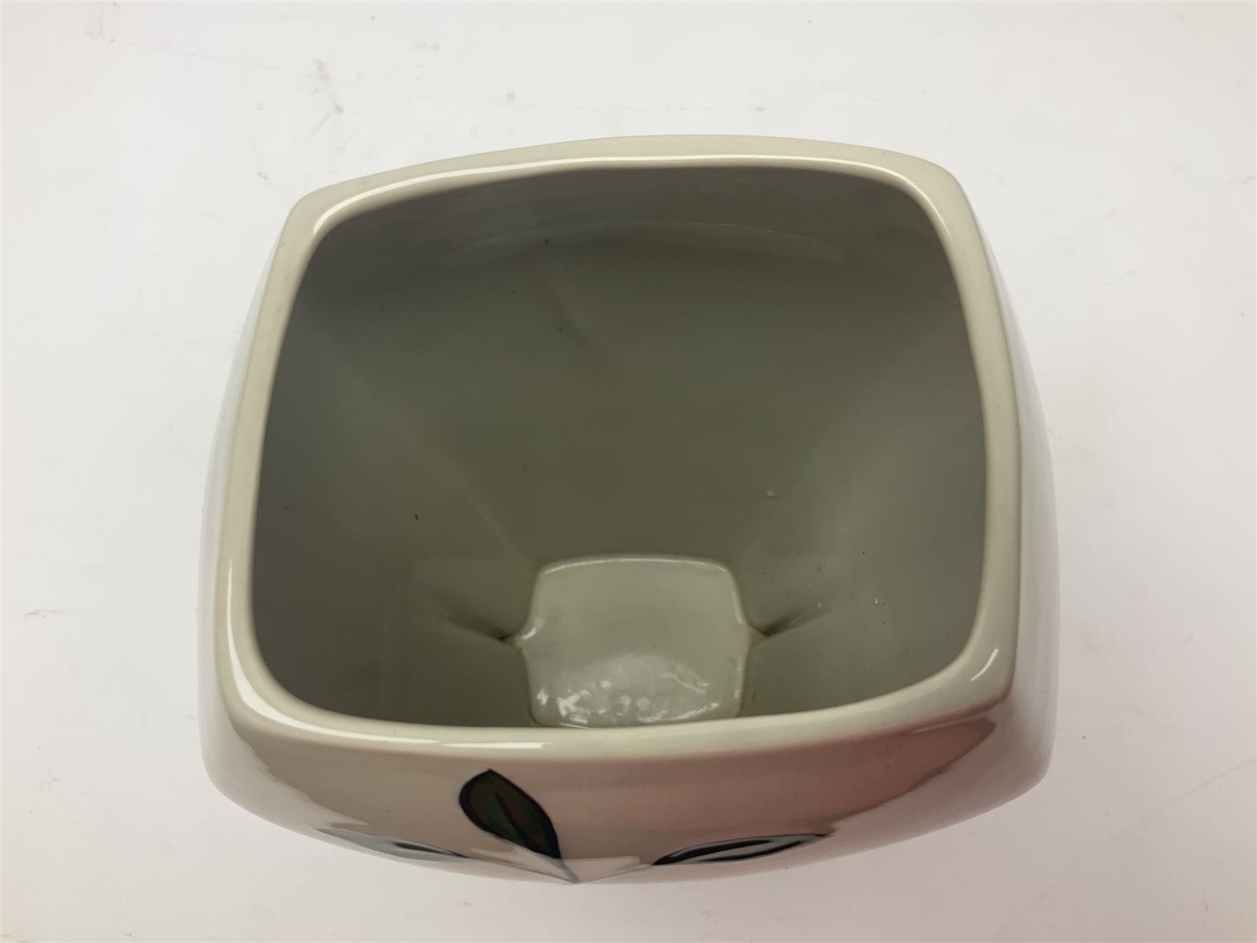 Charlotte Rhead for Crown Ducal ceramics, comprising coffin shaped vase depicting a woman in 1920s dress, a vase with handle, decorated with autumn leaves and a bowl, decorated with flowers and berries, with printed and signed marks beneath, coffin vase H24cm