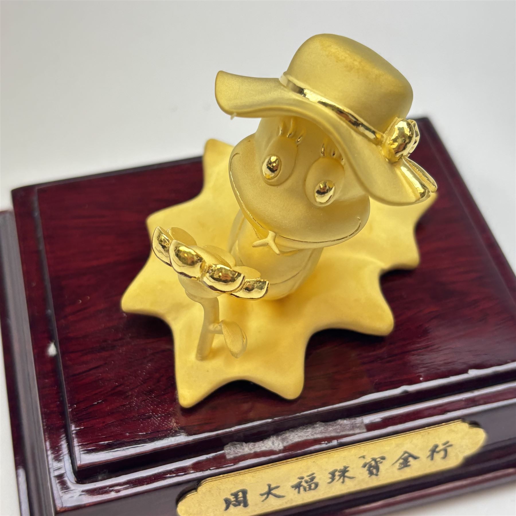 24ct gold model of a snake wearing a hat on a leaf with a sunflower, within a display case, with original box, retailed by Chow Tai Fook Jewellery, Hong Kong