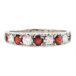 White gold garnet and diamond half eternity ring, nine alternating round brilliant cut dia...