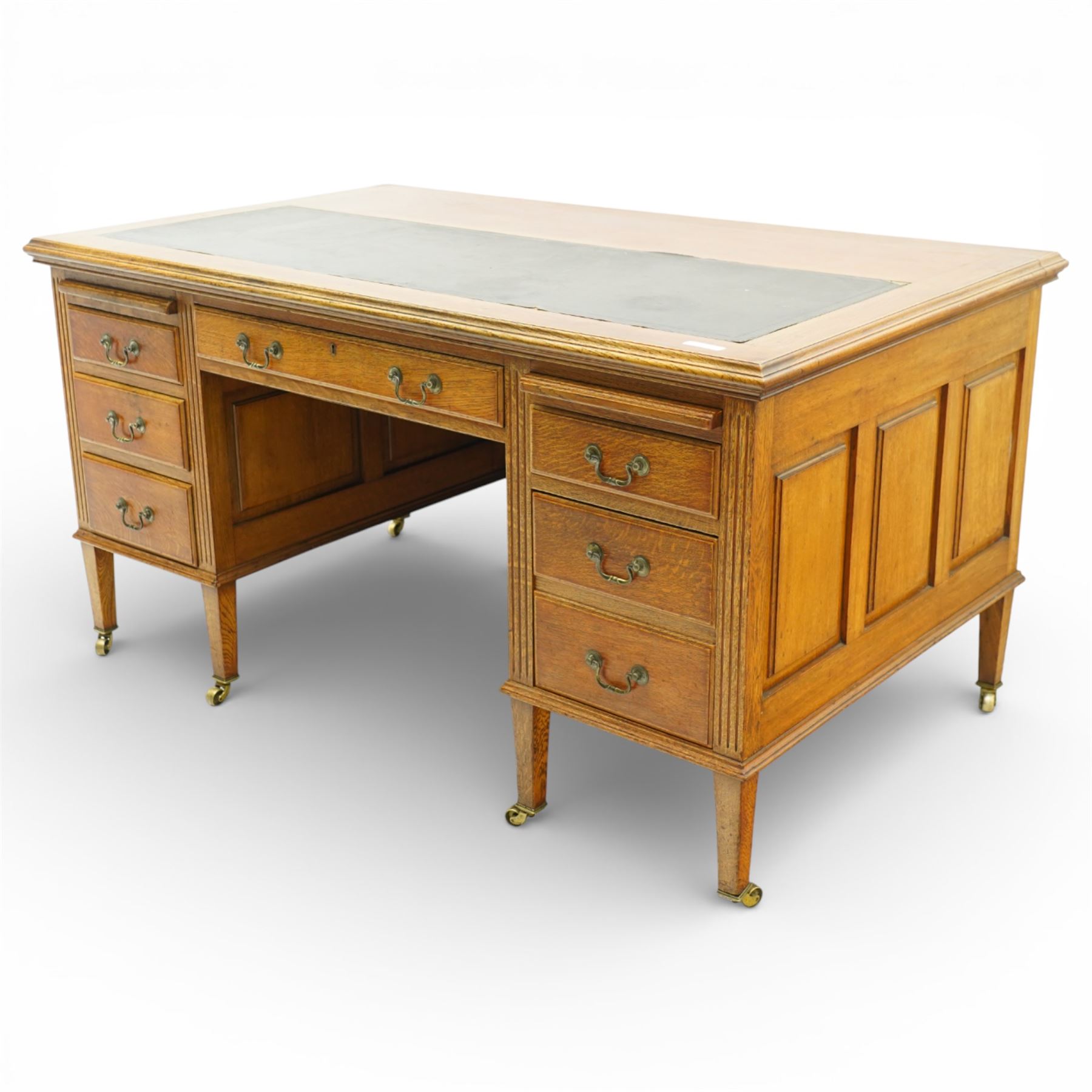 20th century oak kneehole desk, rectangular black leather inset top, above a single frieze drawer, flanked by two pedestals with slides and drawers, panelled sides and back 