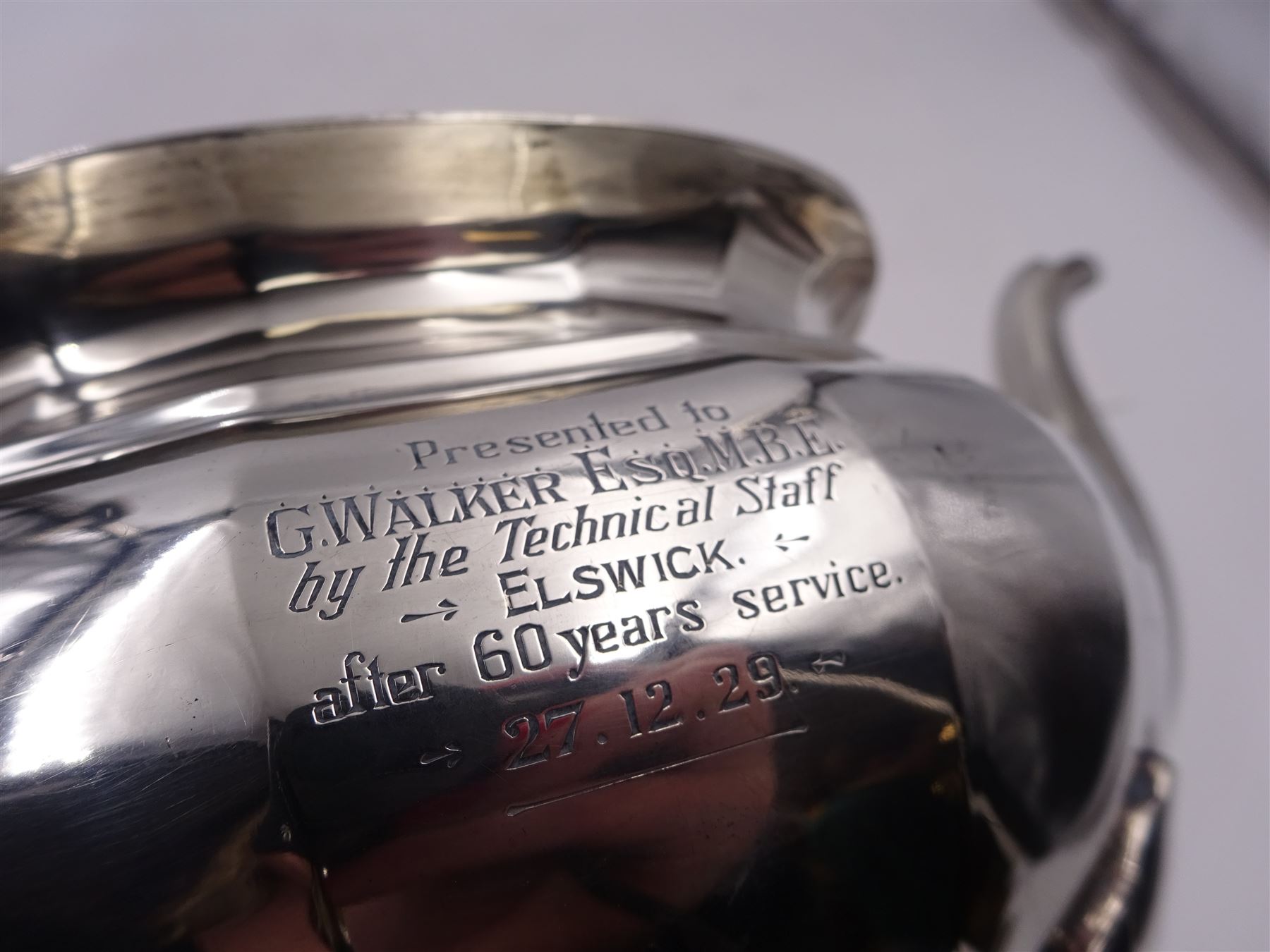 1920s silver teapot, of oval faceted form, with Bakelite type handle and finial, with presentation engraving to body, and upon four paw feet, hallmarked Northern Goldsmiths Co, Birmingham 1929, H16cm