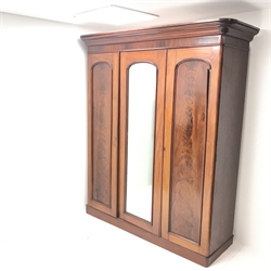 Victorian mahogany triple wardrobe, projecting cornice above single mirrored door flanked by two others enclosing fitted interior, plinth base, W180cm, H210cm, D61cm