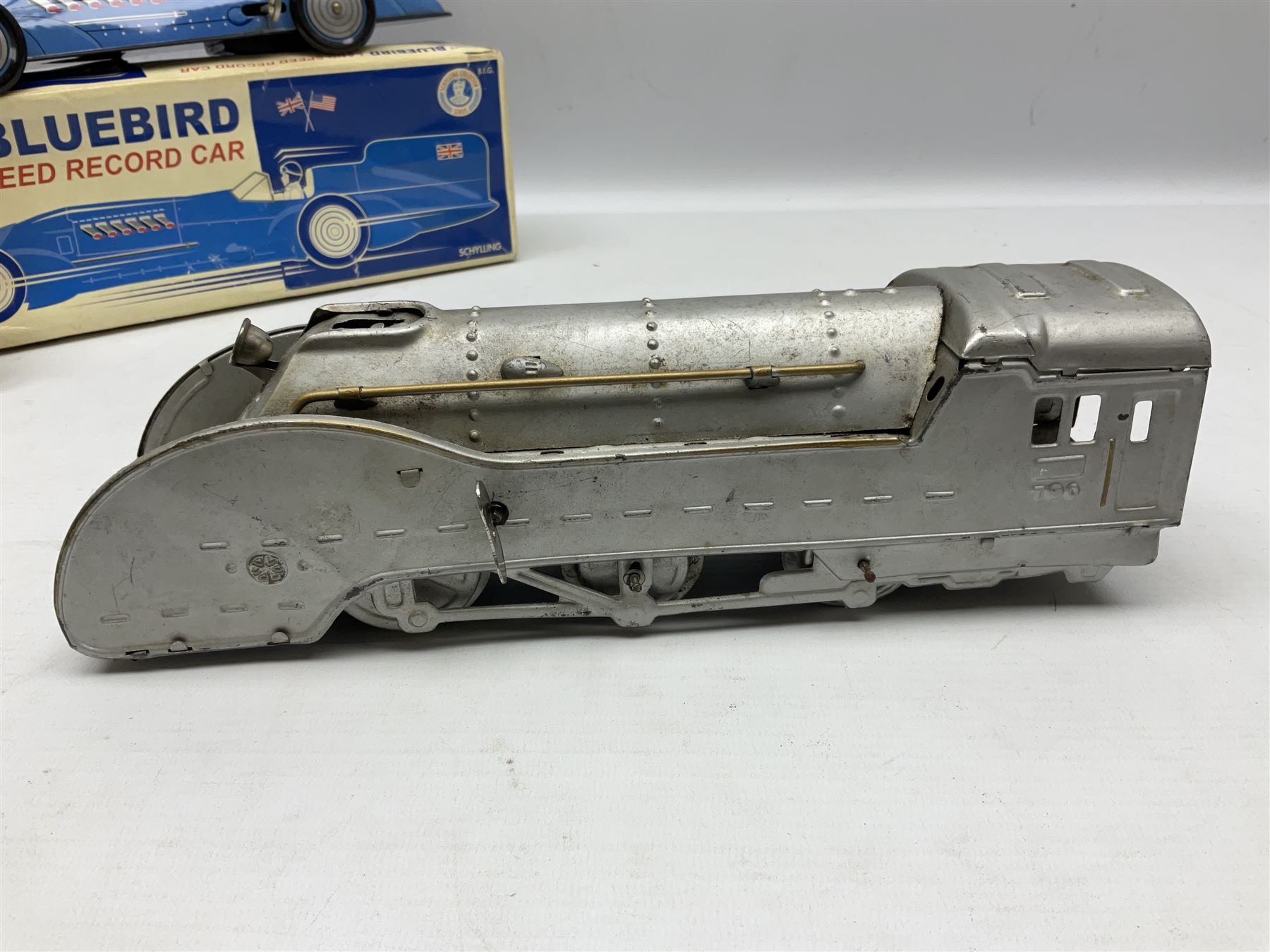 Schylling Collector Series clockwork tin-plate Sir Ian's Bluebird Land Speed Record Car with key and paperwork No.006080; boxed; and clockwork silvered tin-plate model of an 0-6-0 locomotive; unboxed (2)