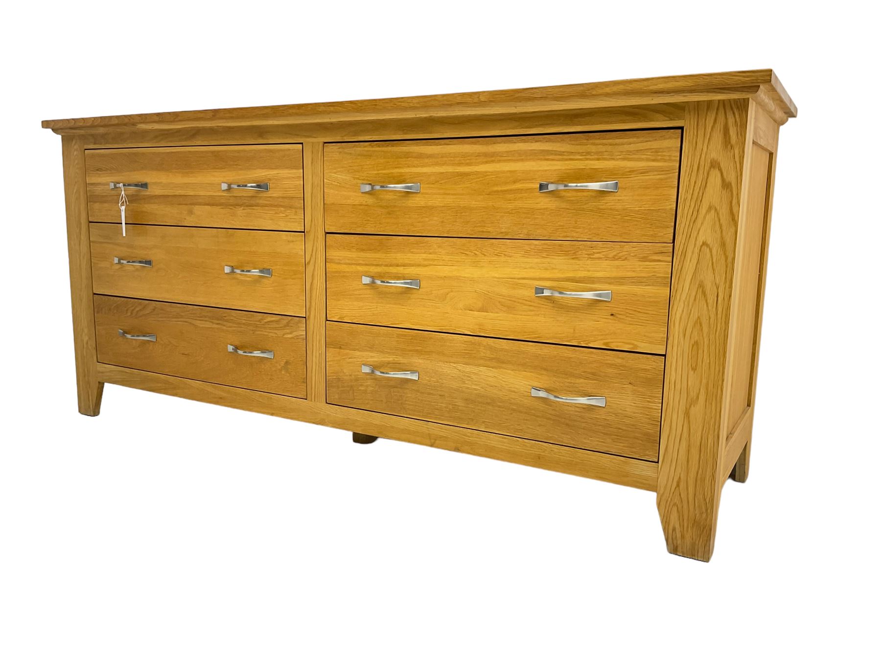 Contemporary wide oak straight-front chest, fitted with a bank of six drawers with chrome handles, on tapered feet