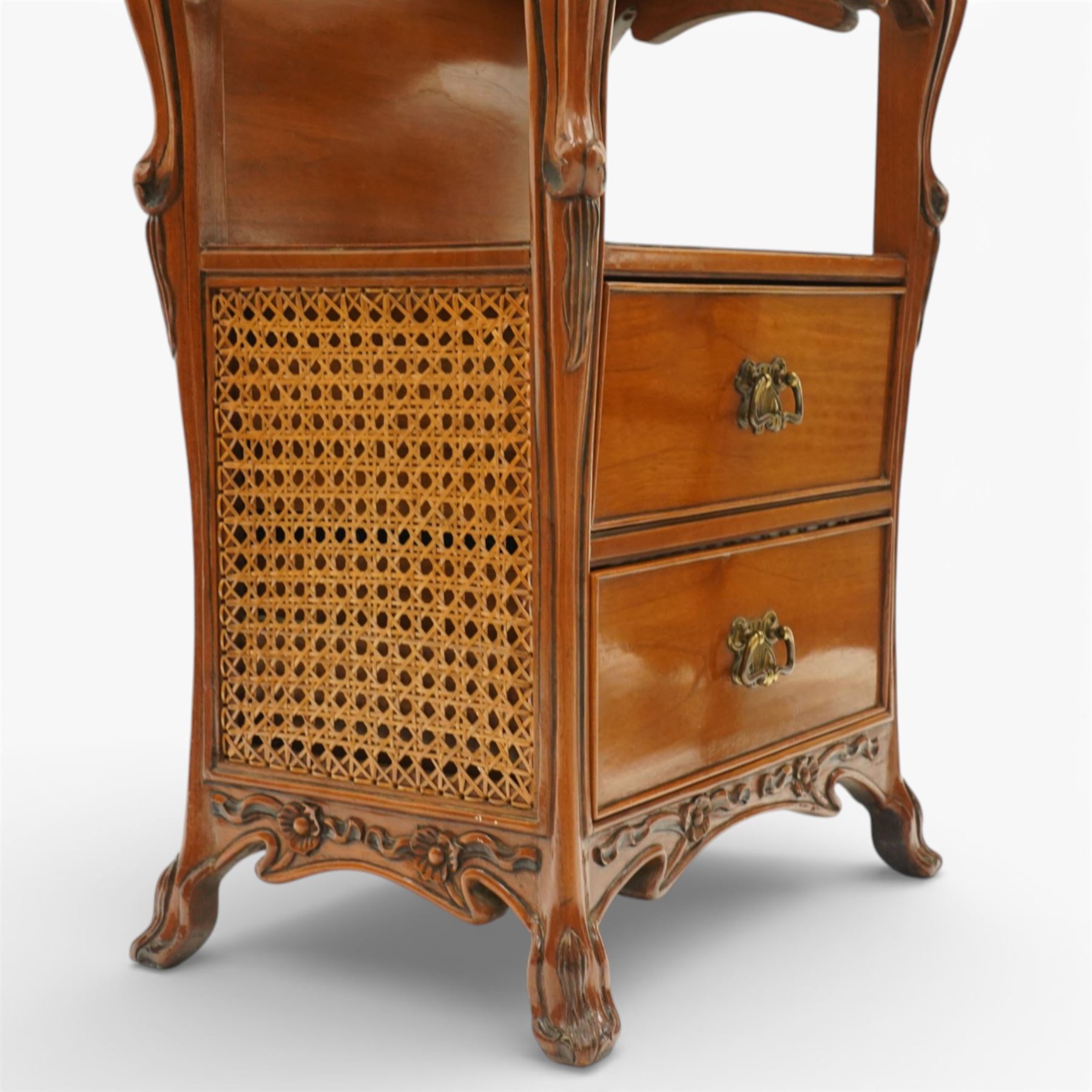 And So To Bed - pair of cherry wood and cane 'Libertine' bedside tables, glass top above a shaped and carved apron, with open recess above two drawers with brass handle, flanked by caned sides, raised on short cabriole supports 