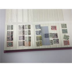 Mostly Great British stamps, including King Edward VII two shillings and sixpence, five shillings and ten shillings, King George V seahorses, King George VI high values, Queen Elizabeth II pre and post decimal etc, housed in a pink stockbook 