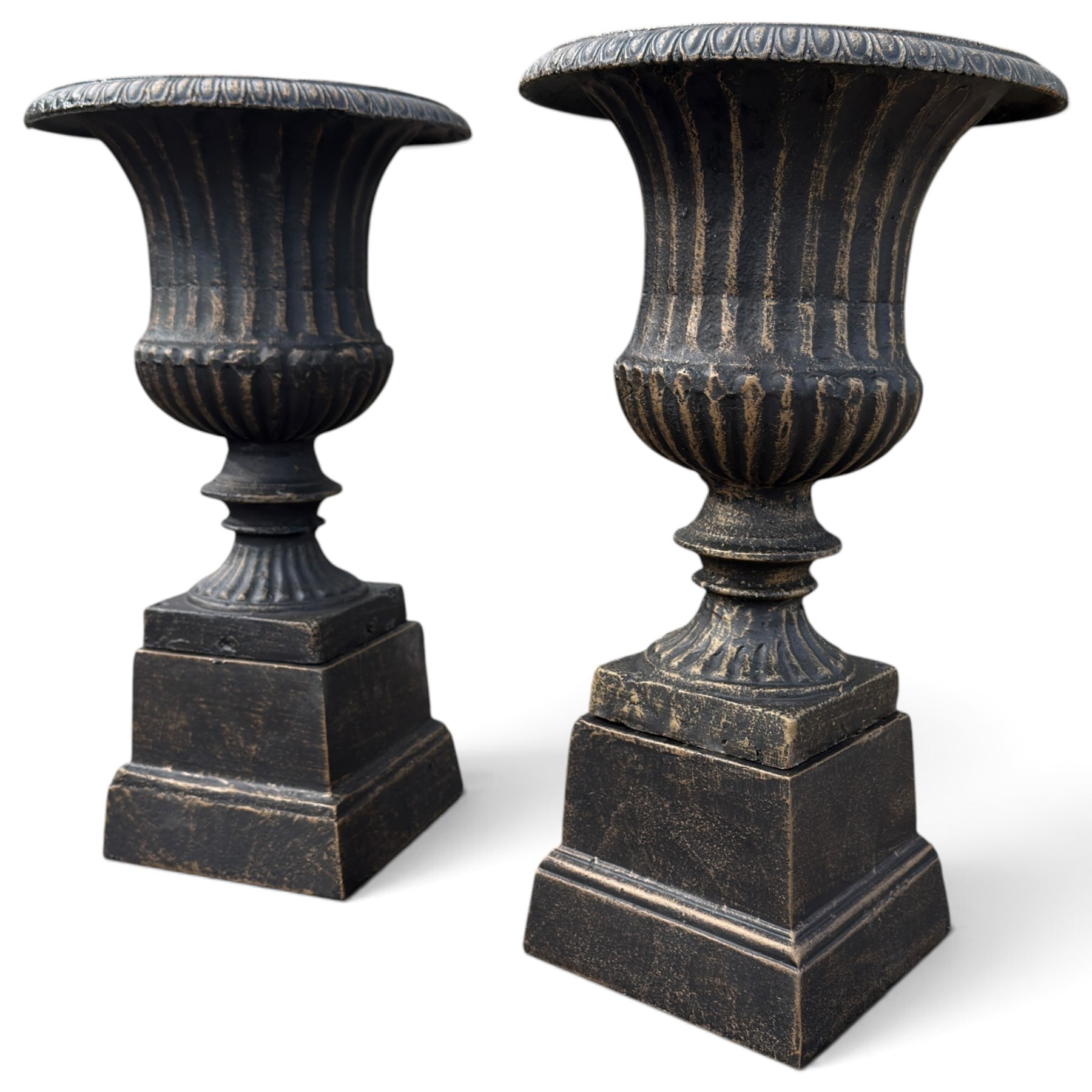 Pair of Neoclassical design black and gilt painted cast iron garden urns of campana form, with egg-and-dart rims and fluted bodies, on knopped stems, fluted socles and stepped square plinth bases