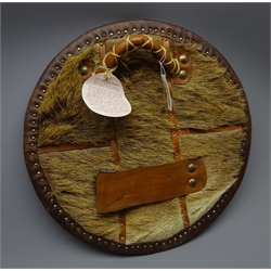  Replica Scottish Highlander's Targe by Joe Lindsay, based on an original 18th century targe which came from the collection of Capt. N.R. Colville, the wooden shield covered in tooled leather with traditional Celtic designs, brass studs and mounts with deer skin hide verso, D49cm   