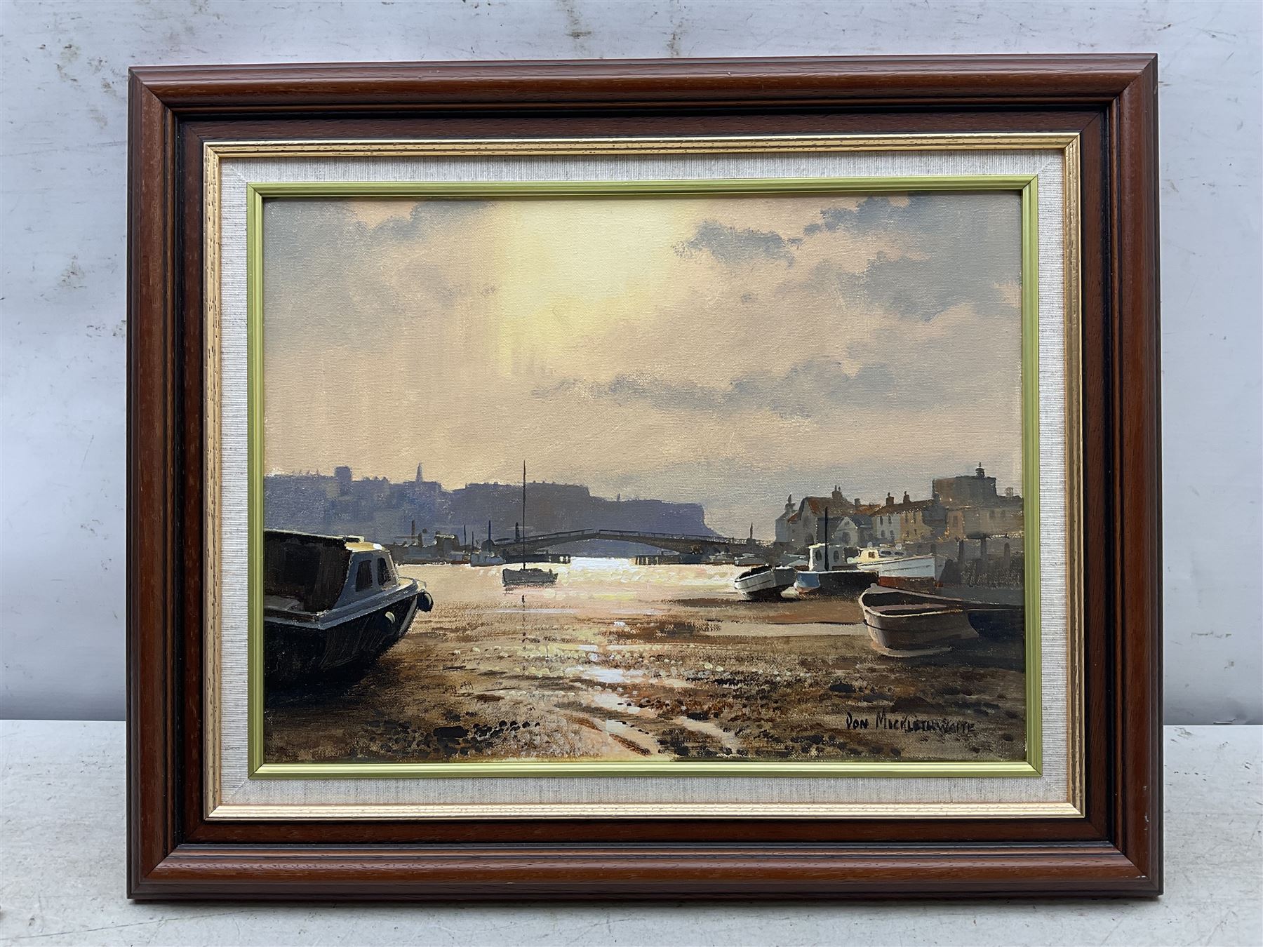Don Micklethwaite (British 1936-): Whitby Swing Bridge at Sunset, oil on canvas signed 30cm x 39cm 