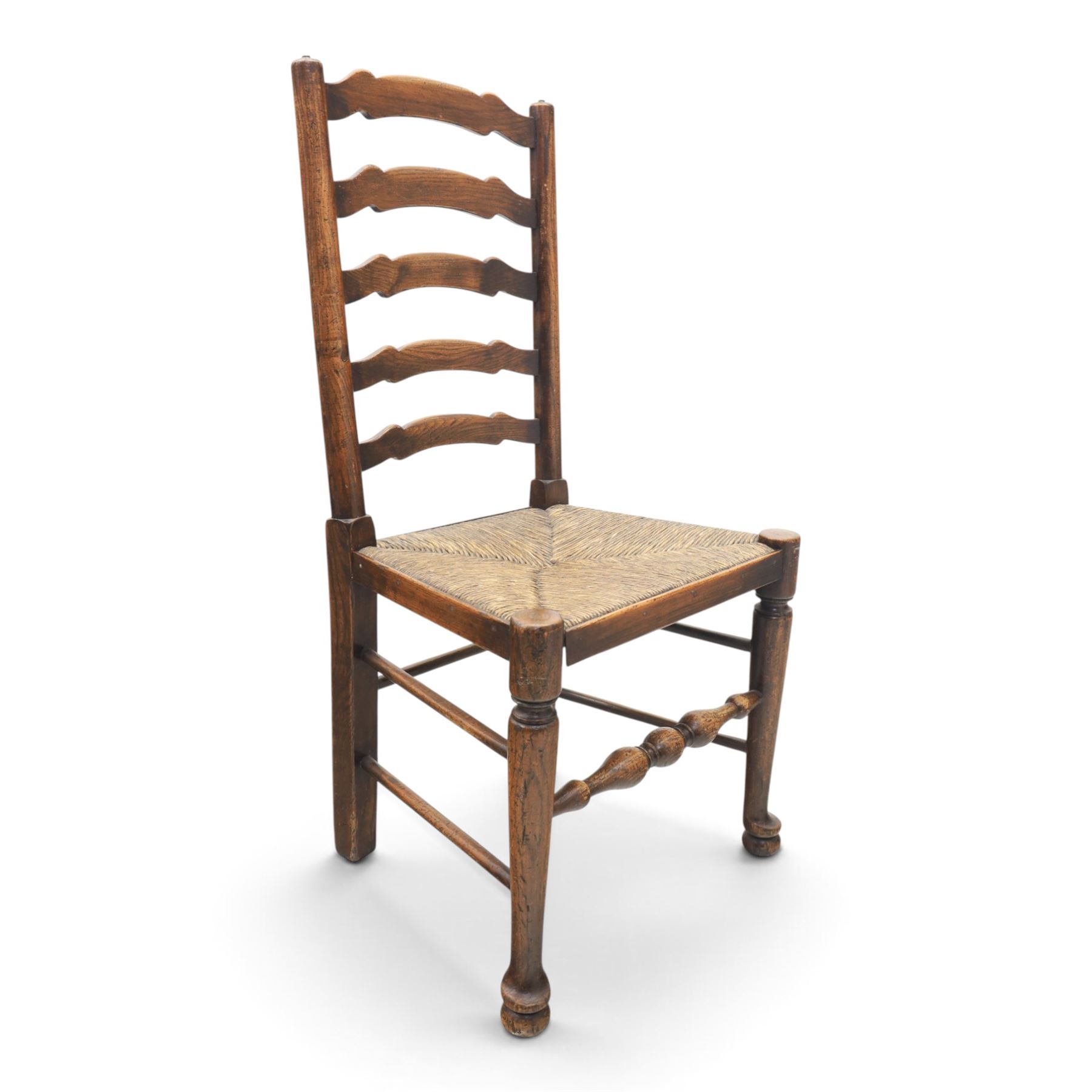 19th century set of six ash and elm ladderback dining chairs, shaped ladder backs above rush seats, raised on turned front supports with pad feet, united by turned stretchers
