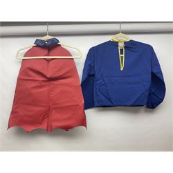 Two Boxed Batman Playsuit Costumes - 1960s 20th Century Original Play Suit, black eye mask, plastic vinyl cape/gauntlets, leather style belt, blue/yellow shirt, with Bat motif and blue/yellow pants; in original illustrated lidded box; and 1976 Decker Batman Playsuit costume, vinyl cape/ mask/gloves/boot tops/yellow belt, grey cloth top and pants; in original illustrated box (2)