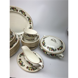 Staffordshire fruit decorated dinner wares, comprising twelve dinner plates, thirteen dessert plates, eighteen bowls, six twin handled soup bowls and six saucers, sauce boat and saucers, two tureen and covers, and a serving platter. 
