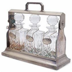 Mappin & Webb silver plated tantalus, with three square glass decanters each with silver plate collars, complete with key, H29cm