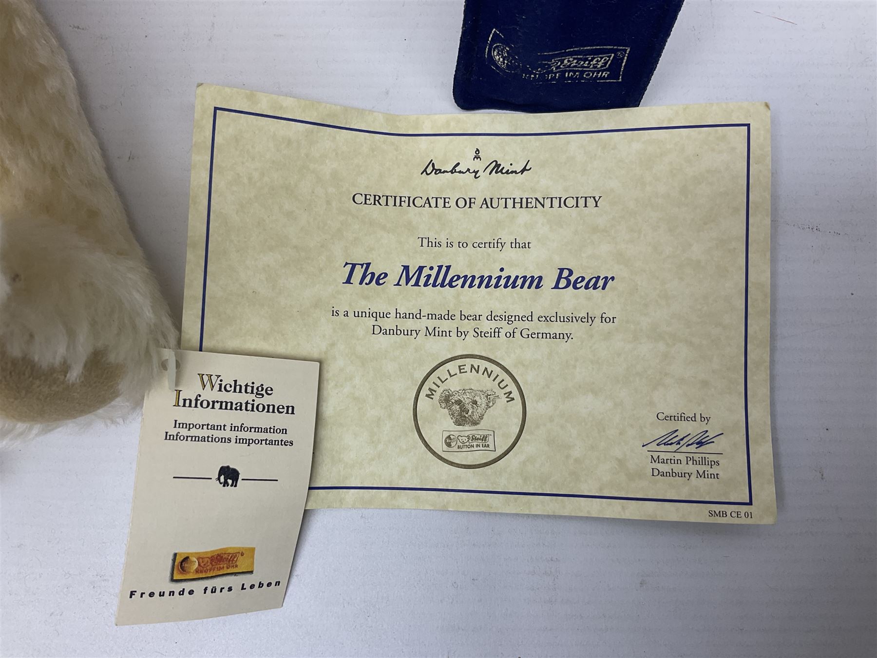 Modern Steiff teddy bear - The Millenium Bear No.34709 with golden pendant H32cm; in original box with paperwork; together with a Steiff ball-point pen in case sent to the vendor as compensation for a delay in receiving the bear.