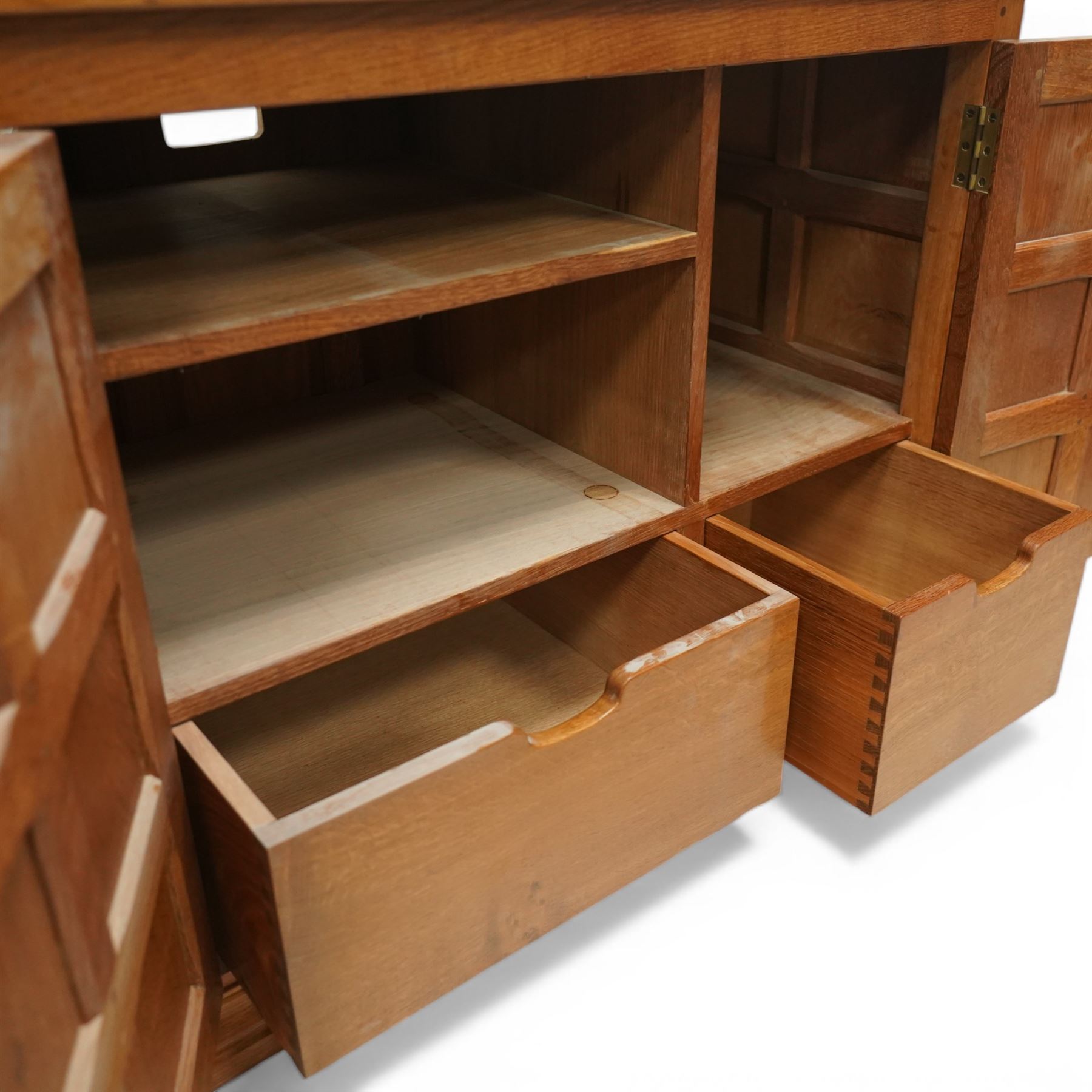  Beaverman - oak media cabinet, rectangular top with interictally carved panels to the side and front doors, twin doors with Yorkshire Rose carved wooden knob, enclosing a staggered shelf arrangement above two drawers, raised on a moulded plinth base, with carved beaver signature, by Colin Almack of Sutton near Thirsk