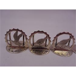 Set of six modern silver place card holders, each of circular form with pierced depictions of a partridge, spaniel, pheasant, stag, woodcock and duck, hallmarked J A Campbell, London 1985, contained within a velvet and silk lined fitted case, H3cm