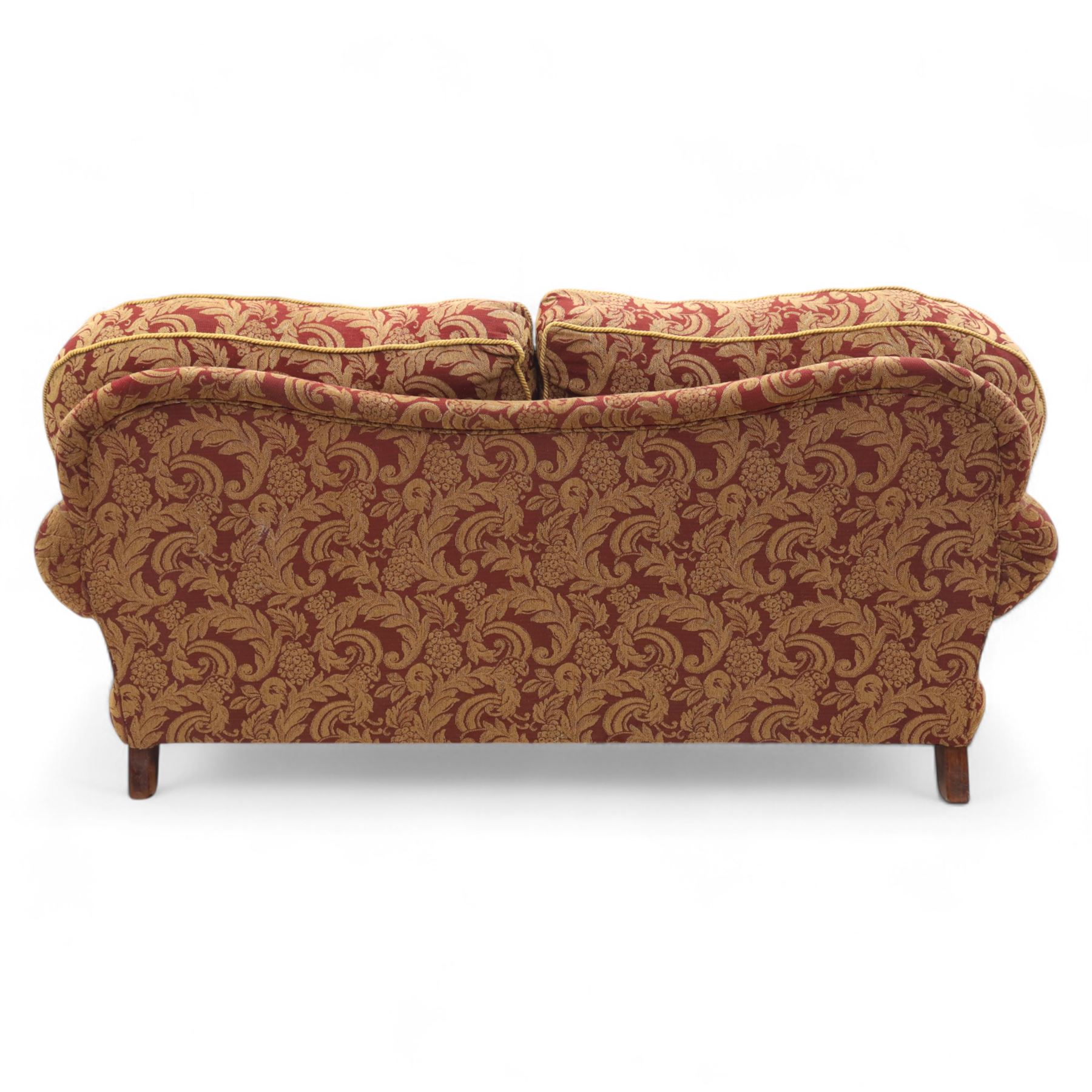 Duresta - two seat settee, upholstered in red and gold damask fabric with piped edges, scroll arms and loose feather-filled cushions, raised on turned wooden feet with brass castors