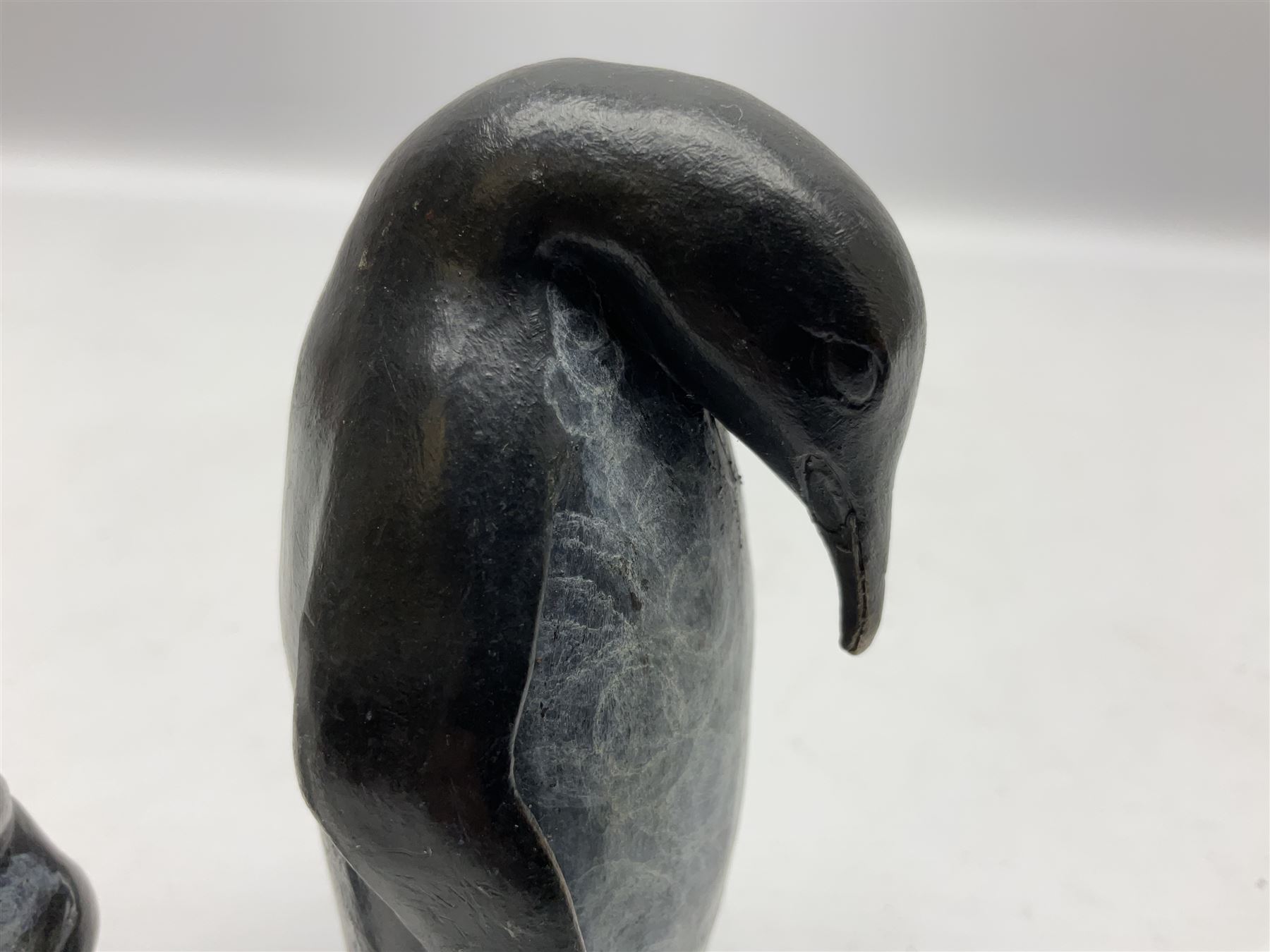 Steve Boss (British 1970-); Bronze figure group of a family of Emperor penguins, entitled Waddle, all with artists monogram beneath, tallest H12cm