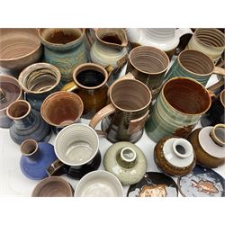 Wold studio pottery tankards, in various colours and relief decoration together with other studio items including vases, jugs and pots 