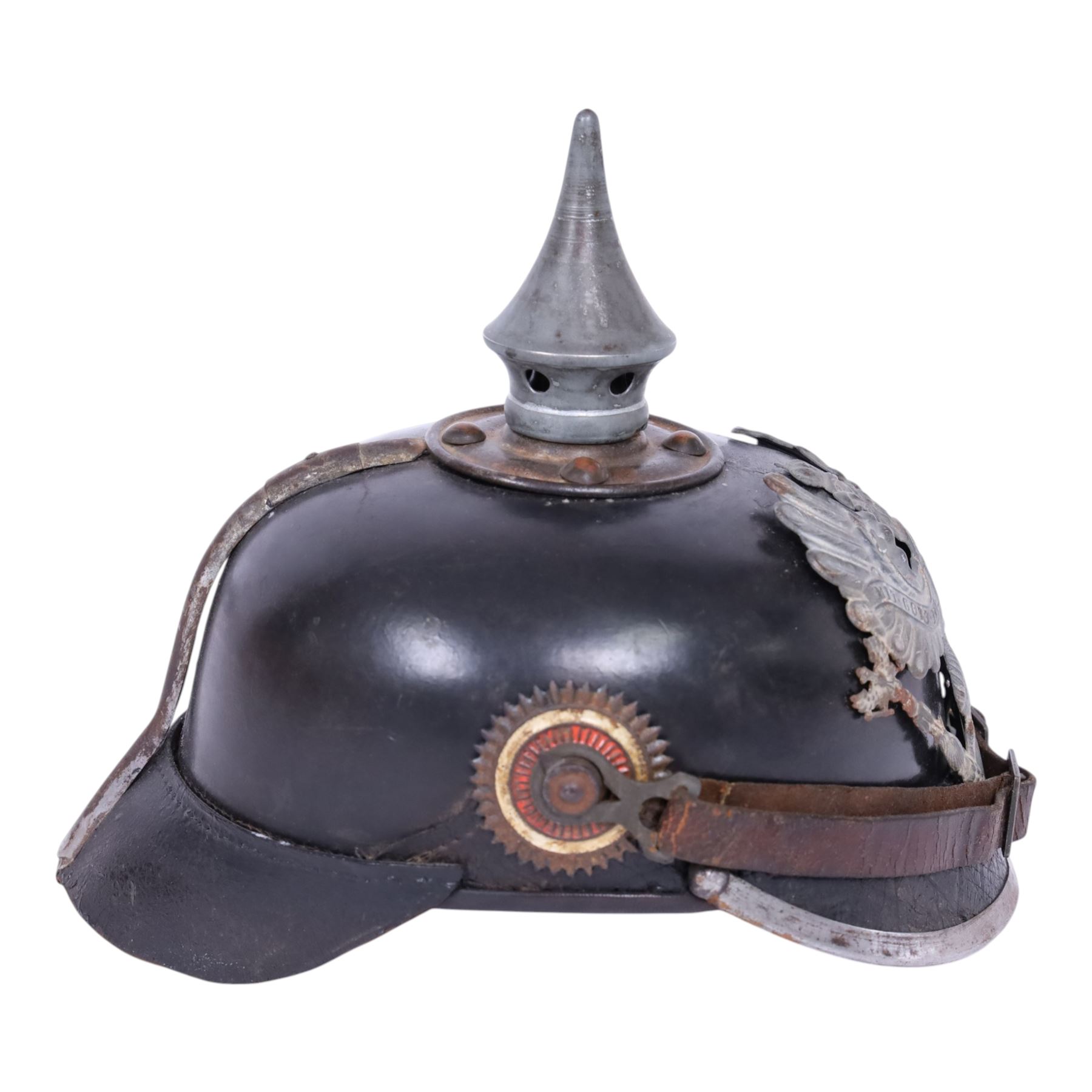 WWI Prussian M1915 Pickelhaube, the black leather skull with removable steel spike finial, steel eagle helmet plate and leather chin strap, one side with a black cockade, the other black and red