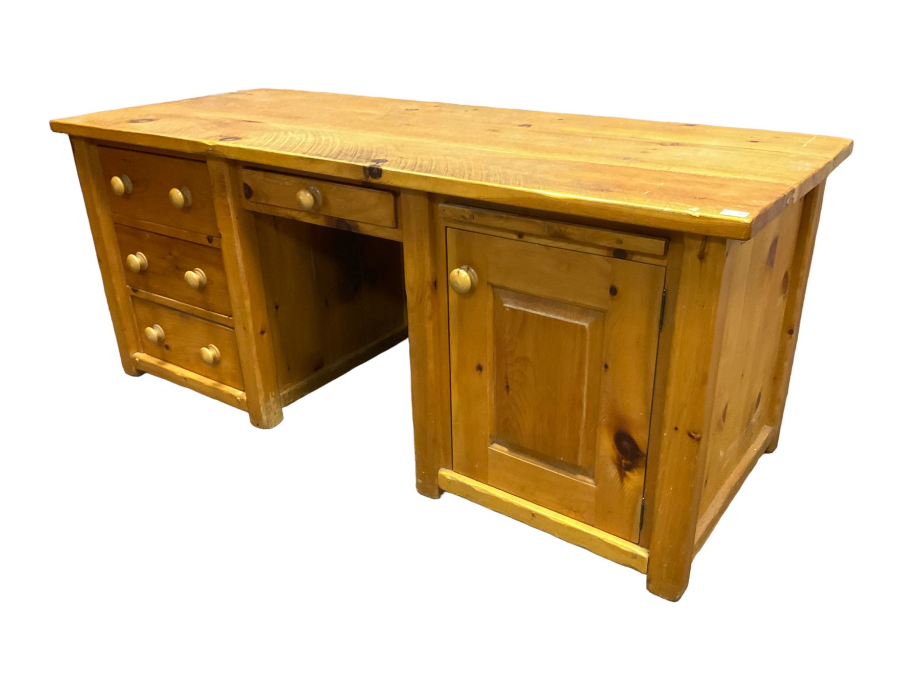 Large pine desk, rectangular top over four drawers, slide and panelled cupboard